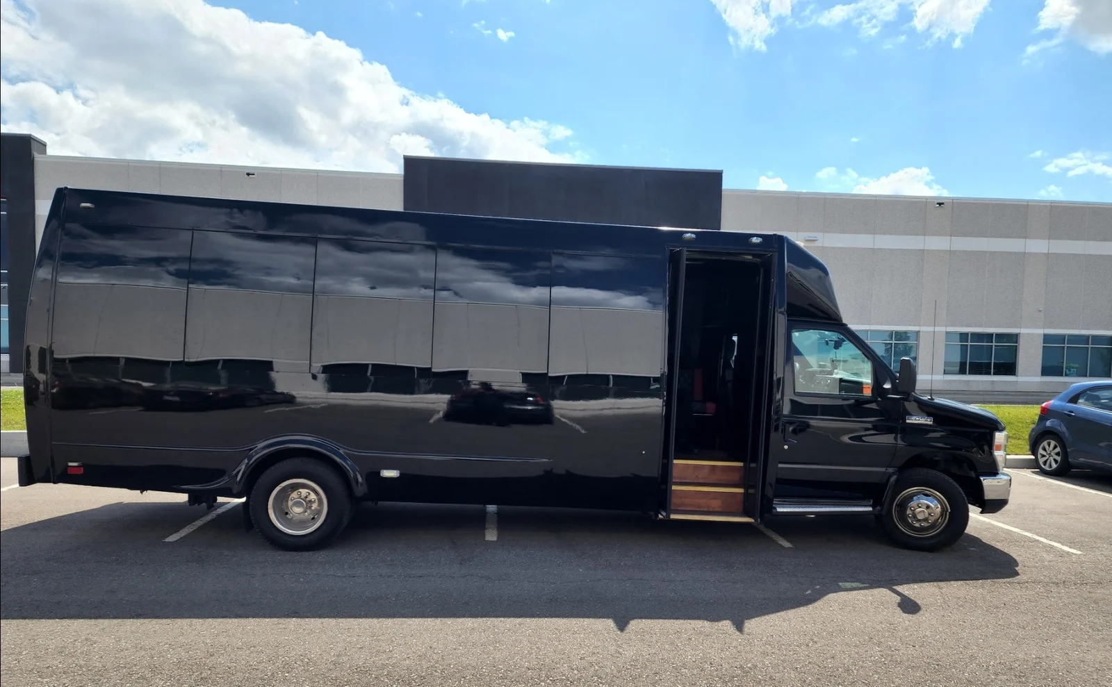 Black ALR charter shuttle bus parked outside and ready for group transportation.